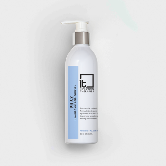 White bottle with pump and blue label on a light gray background