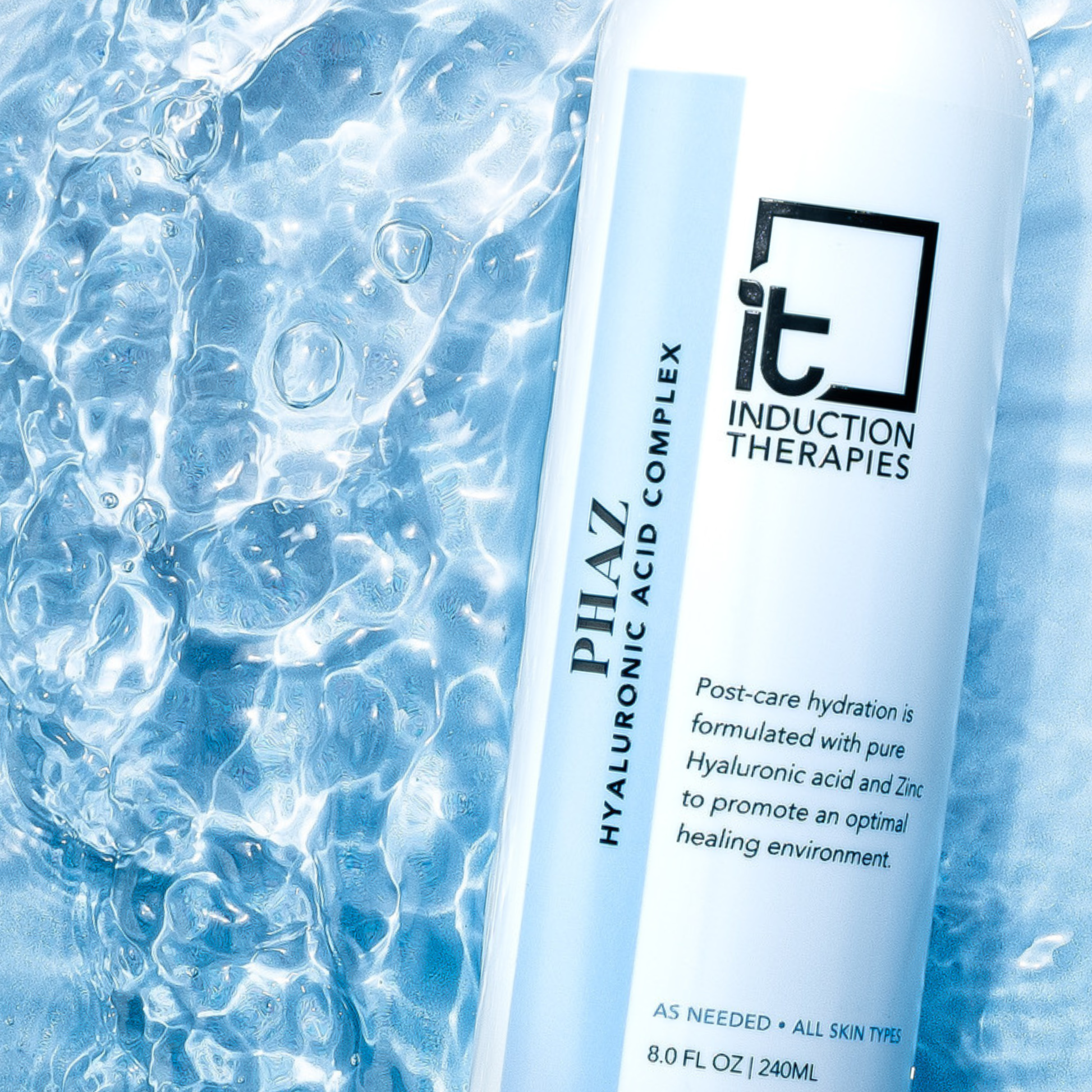 Skincare product with 'Induction Therapies' branding against a blue, water-like background